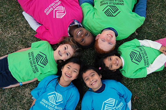 6 young kids lying down in a circle